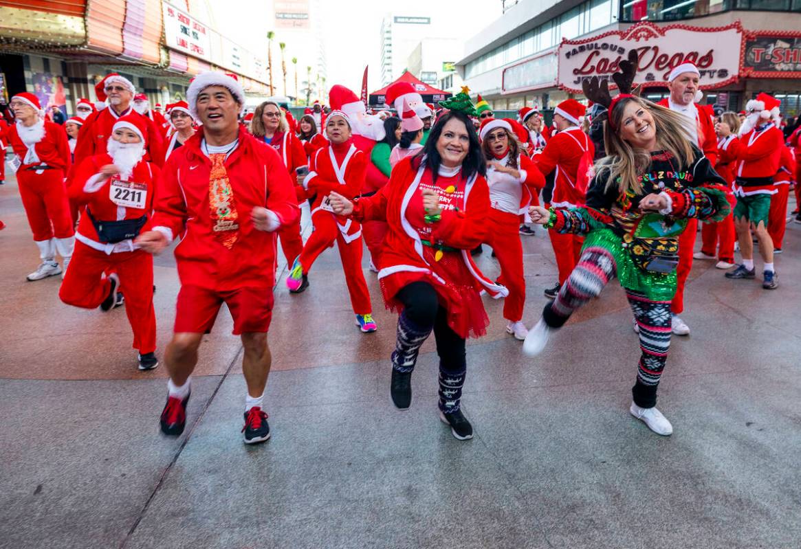 Left to right, Ron and Dale Endo and Kelly Harris dance with others during the pre-race enterta ...