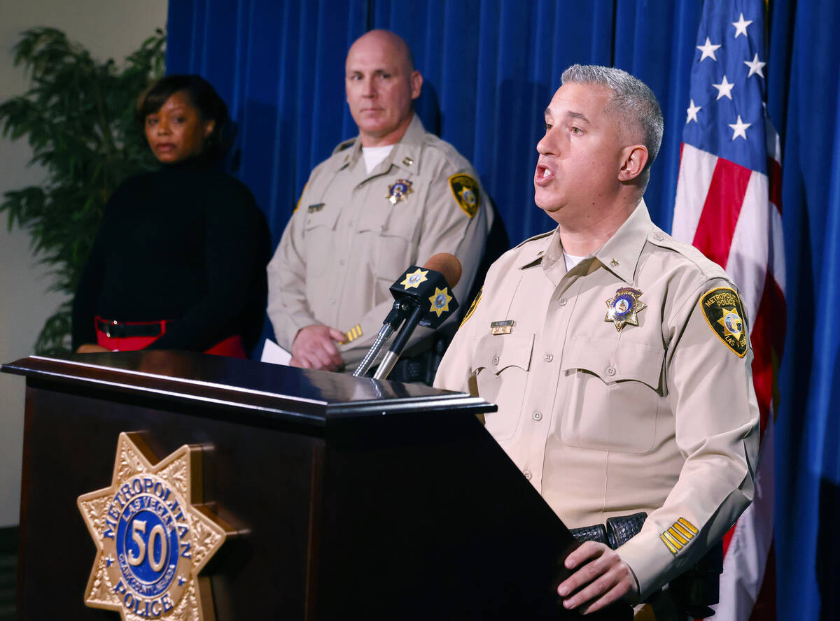 LVMPD Deputy Chief Nicholas Farese, speaks as Capt. Hector Cintron, center, and Kimberly Small, ...