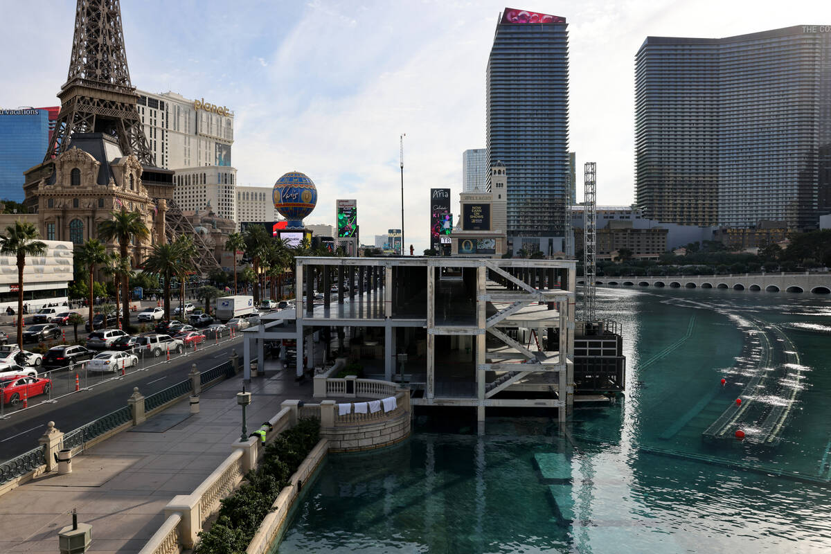 Workers dismantle Formula One grandstands and luxury boxes at the Bellagio fountains on the Str ...