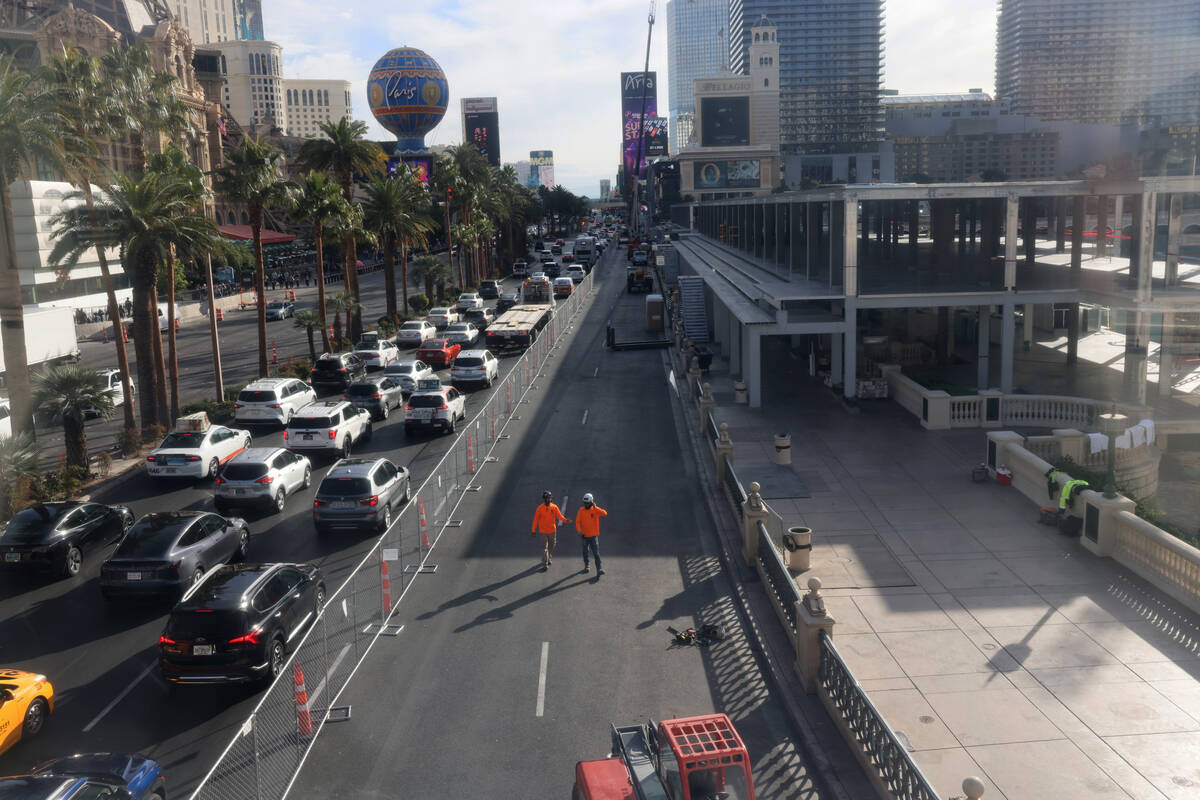 Workers dismantle Formula One grandstands and luxury boxes at the Bellagio fountains on the Str ...