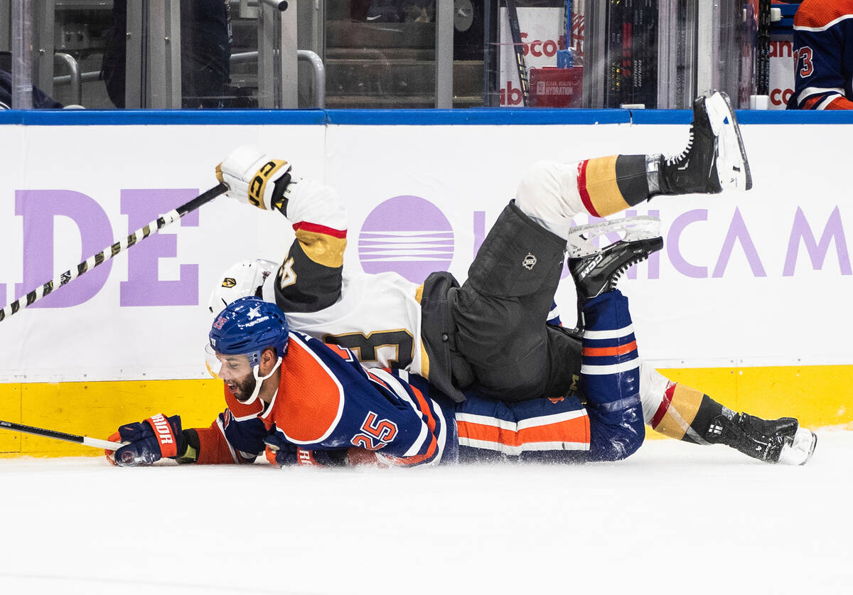 Vegas Golden Knights' Paul Cotter (43) and Edmonton Oilers' Darnell Nurse (25) collide during t ...