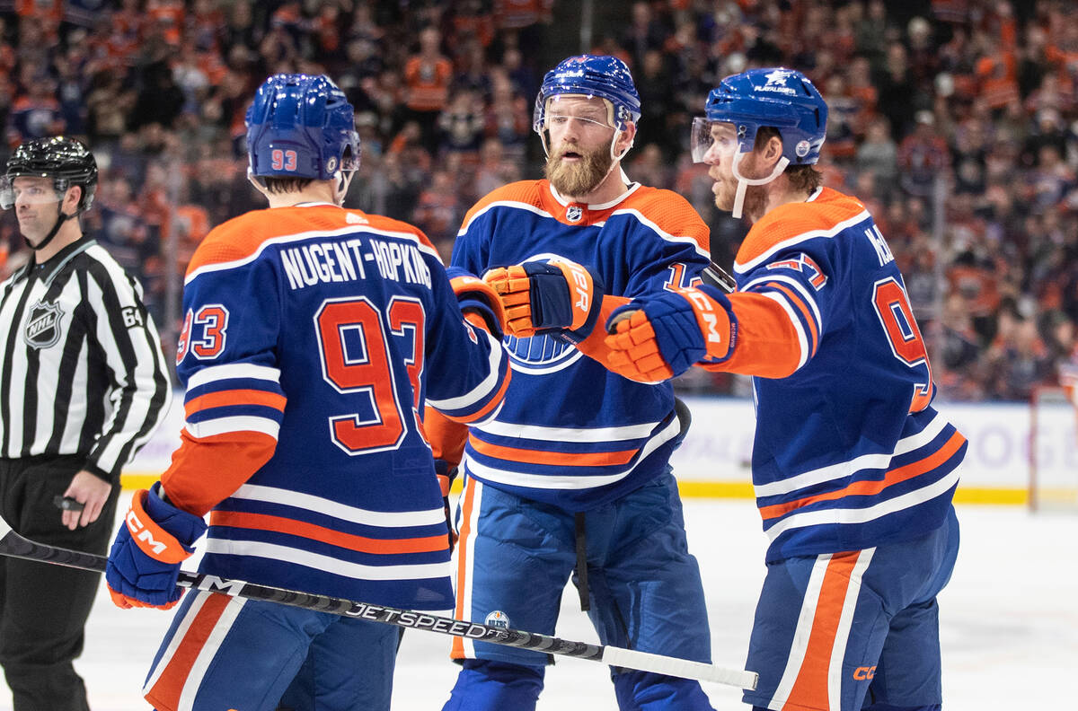 Edmonton Oilers' Ryan Nugent-Hopkins (93), Mattias Ekholm (14) and Connor McDavid (97) celebrat ...