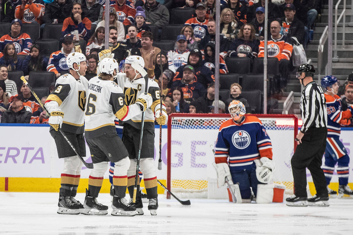 Vegas Golden Knights' Brayden McNabb (3), Kaedan Korczak (6) and Mark Stone (61) celebrate a go ...