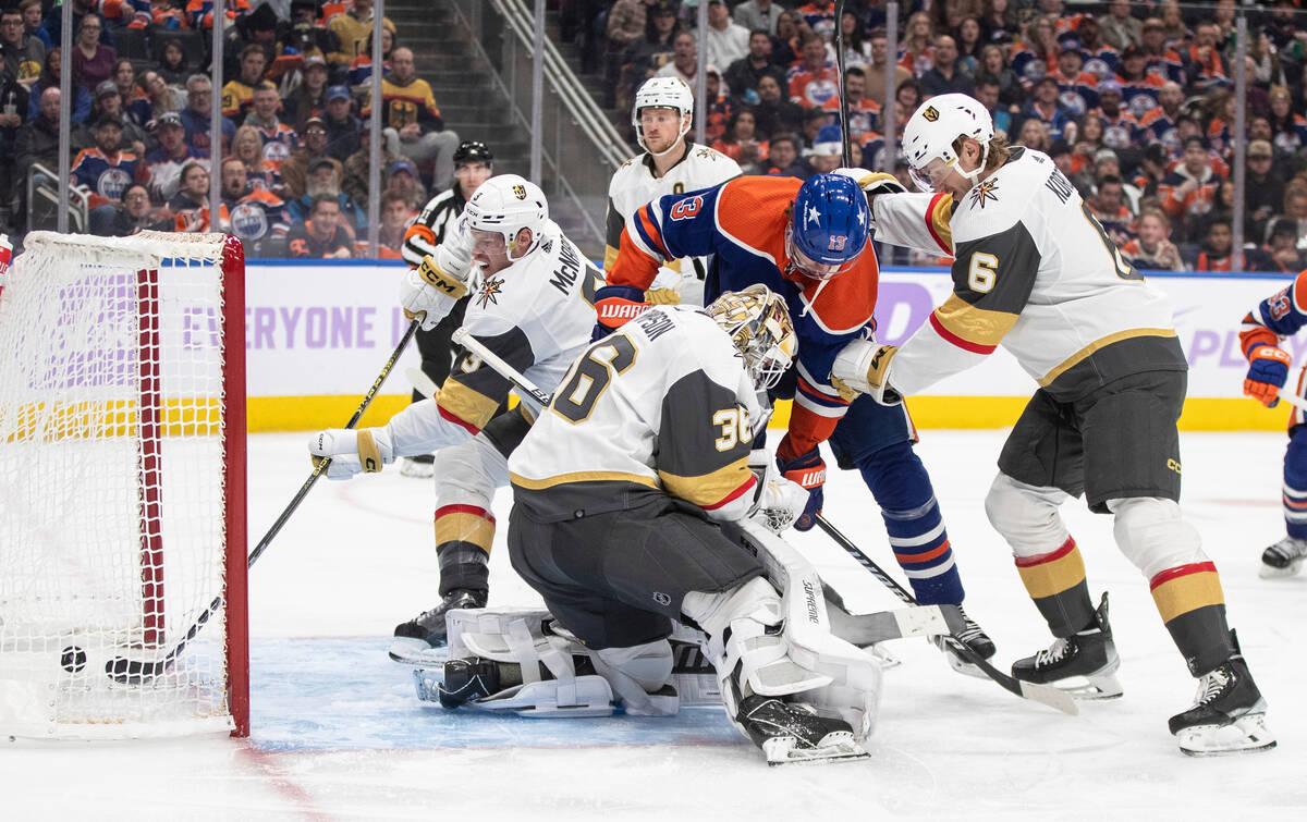 Vegas Golden Knights' Brayden McNabb (3) tries to pull the puck out of the net as it goes past ...