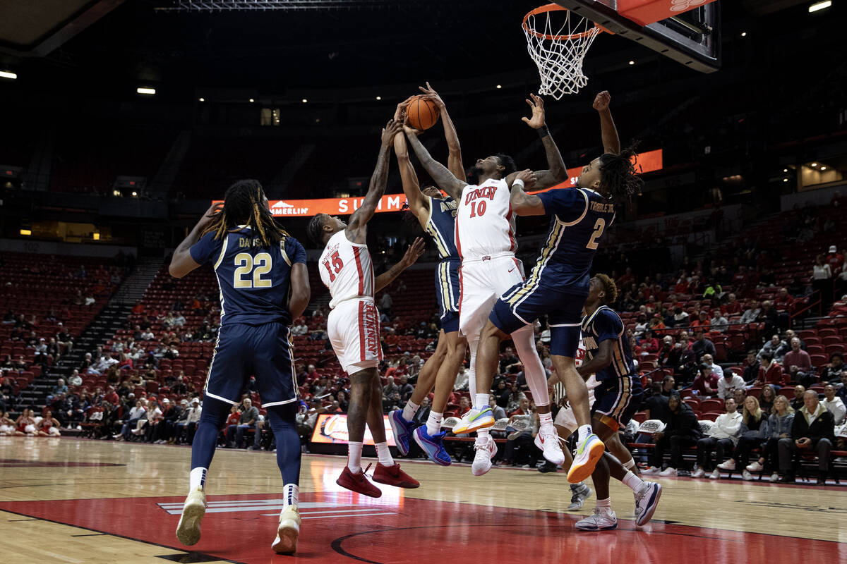 UNLV Rebels guard Luis Rodriguez (15) and forward Kalib Boone (10) jump for a rebound against A ...