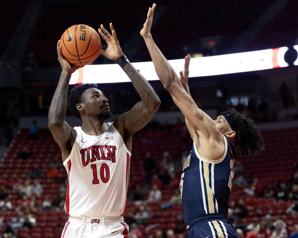 UNLV Rebels forward Kalib Boone (10) shoots against Akron Zips forward Enrique Freeman (25) dur ...