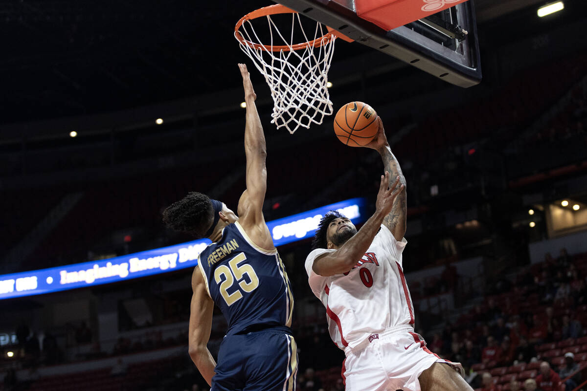 UNLV Rebels forward Isaiah Cottrell (0) shoots against Akron Zips forward Enrique Freeman (25) ...