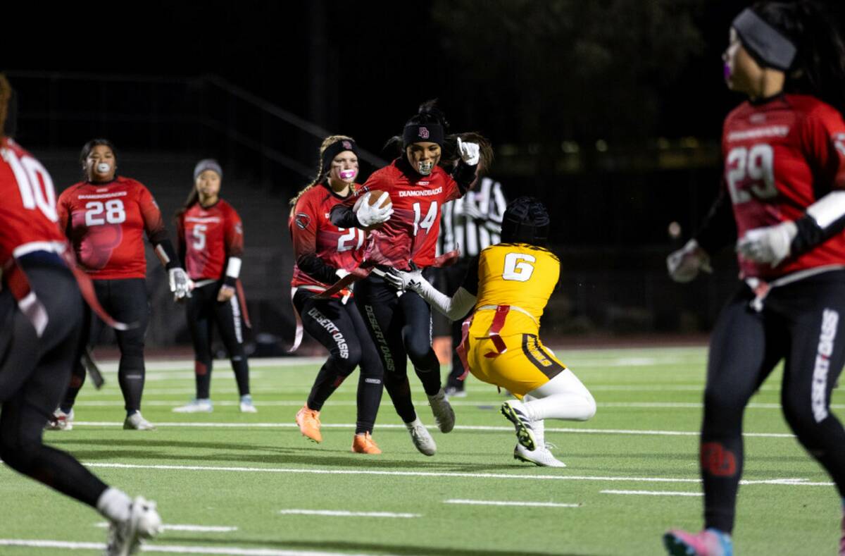 Desert Oasis’ Allie Peralta (14) runs through defense by Bonanza’s Larein Caballero (6) dur ...