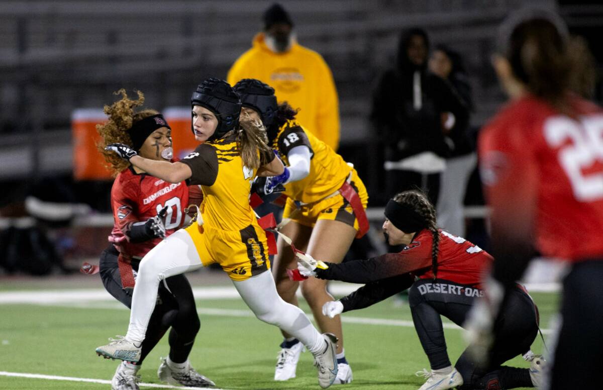 Bonanza’s Reagan Coupe (6) runs the ball while Desert Oasis’ Fatima Topete (50) takes her f ...