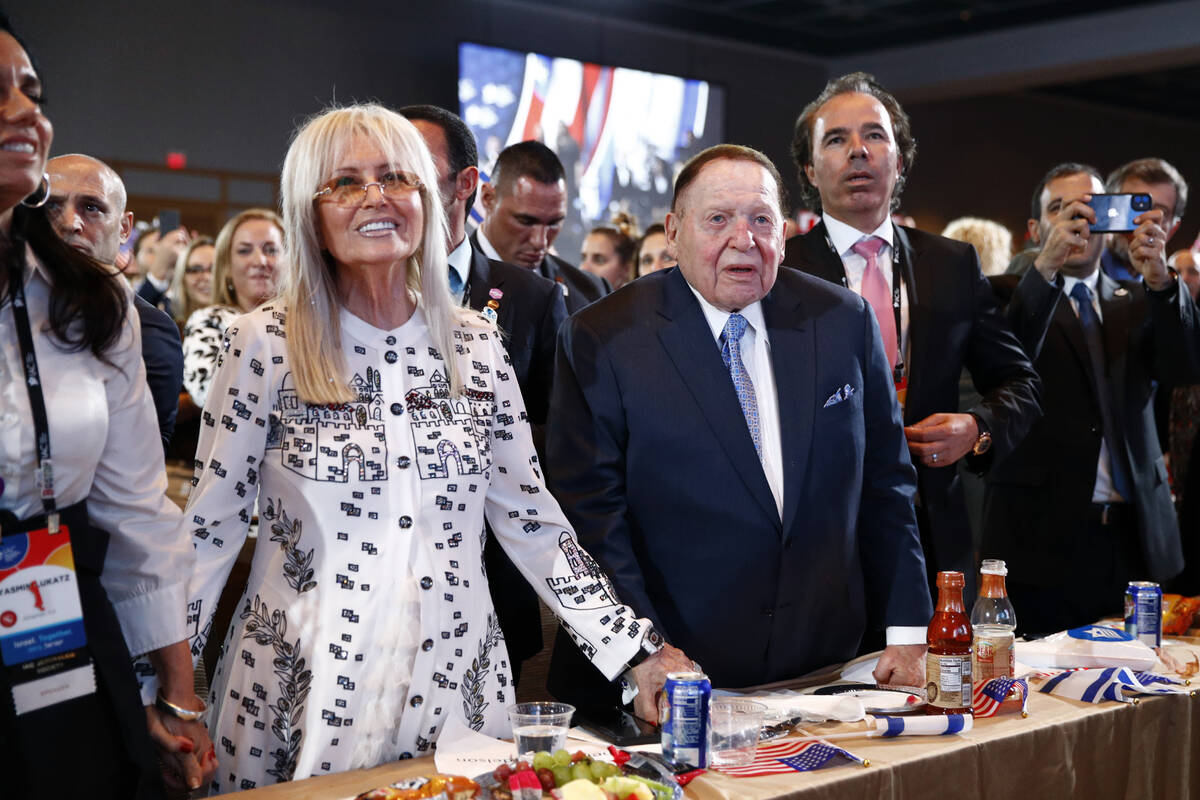 Las Vegas Sands Corporation Chief Executive and Republican mega donor Sheldon Adelson, center, ...