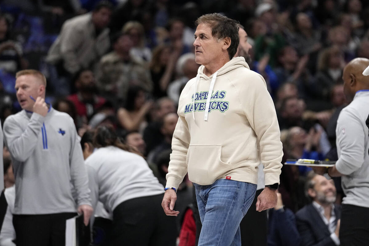 Dallas Mavericks team owner Mark Cuban walks to his seat during the first half of an NBA basket ...