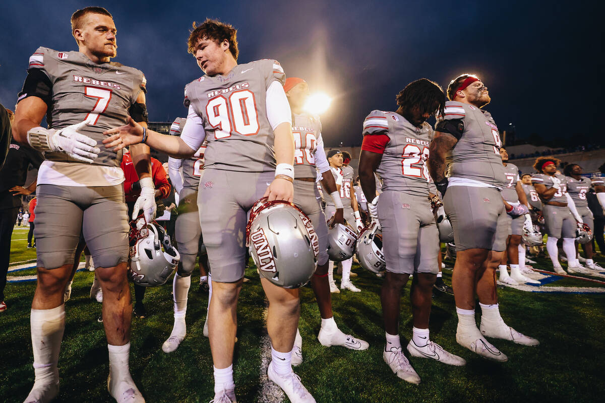 UNLV teammates Jackson Woodard (7) and Marshall Nichols (90) shake hands after beating Air Forc ...