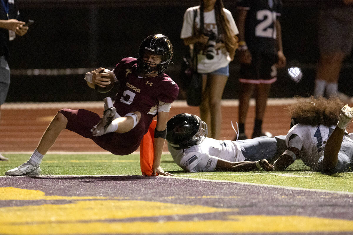 Faith Lutheran quarterback Garyt Odom (3) scores a touchdown while Desert Pines can’t st ...