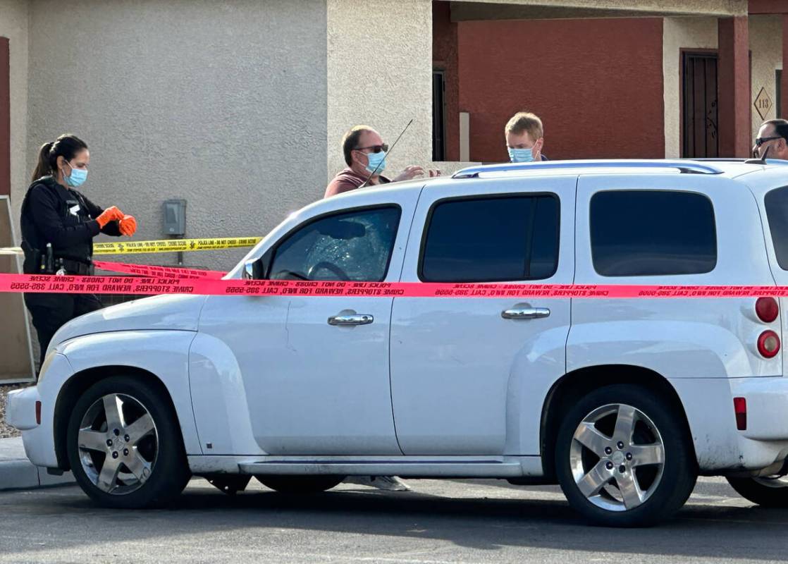 Investigators are seen at an apartment complex near J Street and Monroe Avenue, where police ta ...