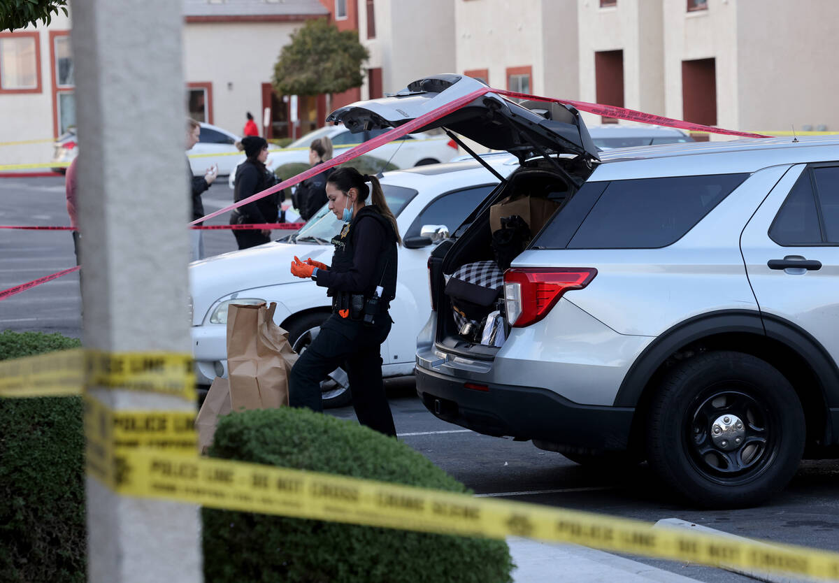 Las Vegas police investigate a white Chevrolet HHR in a housing complex on Monroe Avenue near I ...