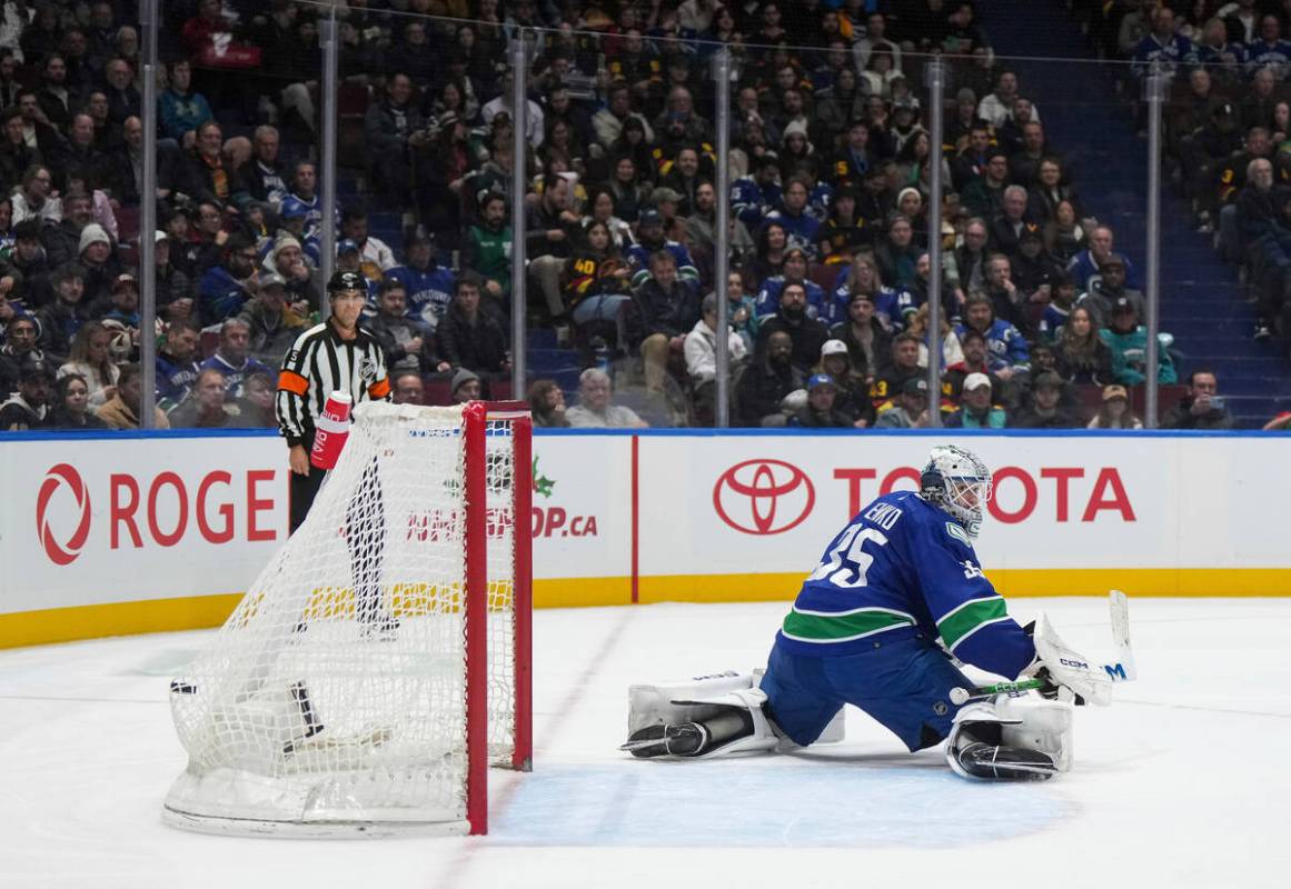 Vancouver Canucks goalie Thatcher Demko allows a goal to Vegas Golden Knights' William Karlsson ...