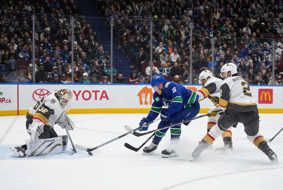 Vancouver Canucks' Sam Lafferty (18) is stopped by Vegas Golden Knights goalie Logan Thompson ( ...