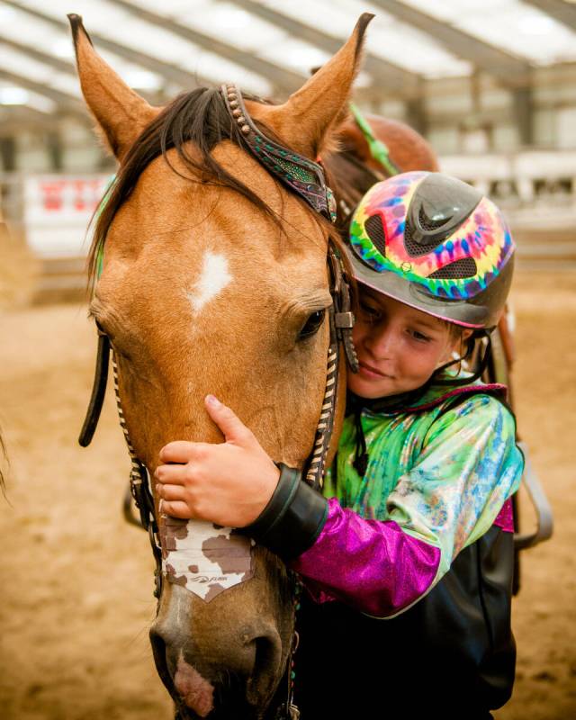 Rori Fenner hugs her Buckskin gelding Mr Star Bogie "Bucky" in thanks after winning a race in W ...