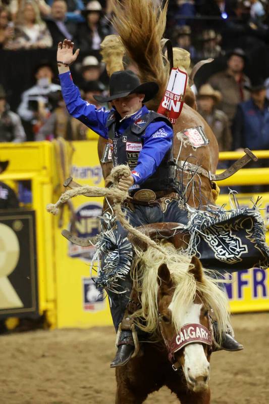 Stetson Wright of Milford, Utah, competes in the saddle bronc riding event during the ninth go- ...