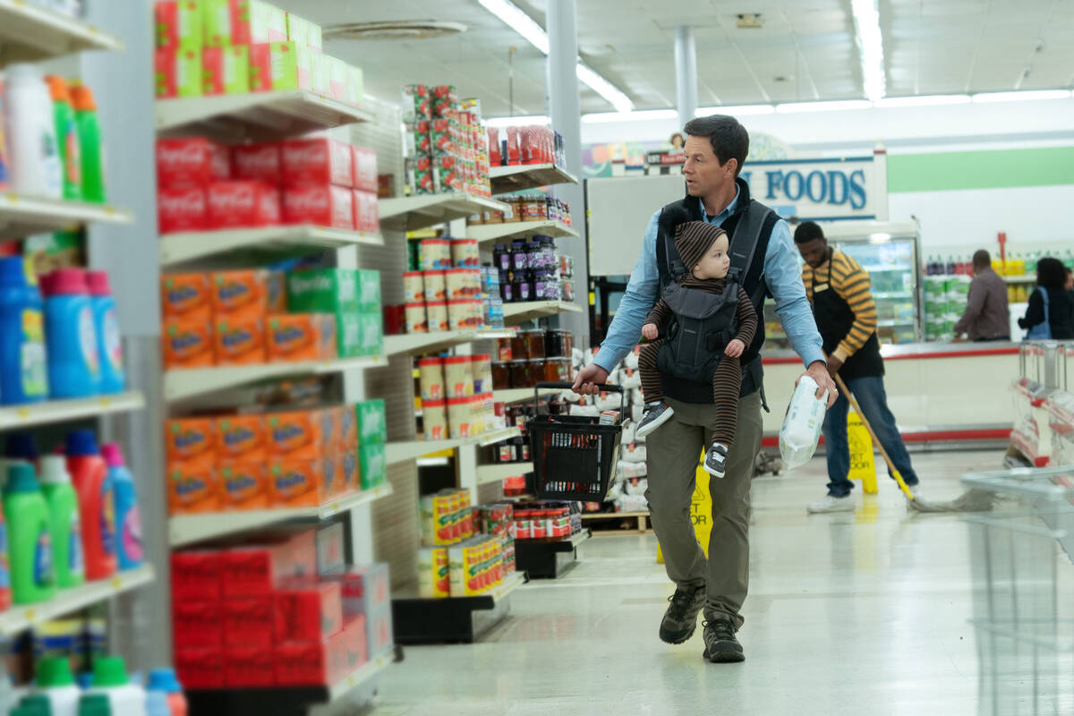 Mark Wahlberg with Iliana Norris in a scene from "The Family Plan," premiering Decemb ...