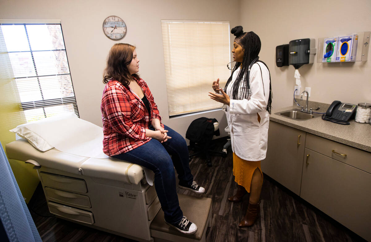 Lilnetra Grady, chief medical officer at FirstMed Health and Wellness Center, right, talks with ...