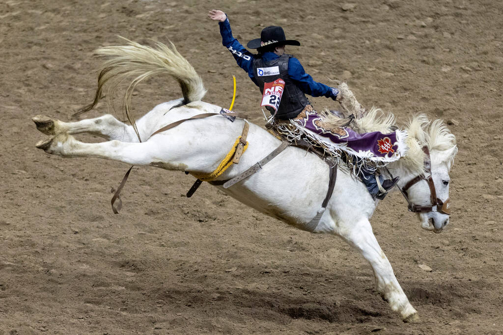 Logan Hay, of Wildwood, Alberta, Canada, competes in saddle bronc riding during the seventh go- ...