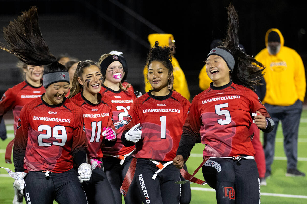 Desert Oasis, including quarterback Akemi Higa (5), celebrates their win against Bonanza in a h ...