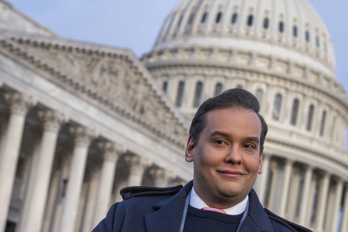 Rep. George Santos, R-N.Y., faces reporters at the Capitol in Washington, early Thursday, Nov. ...