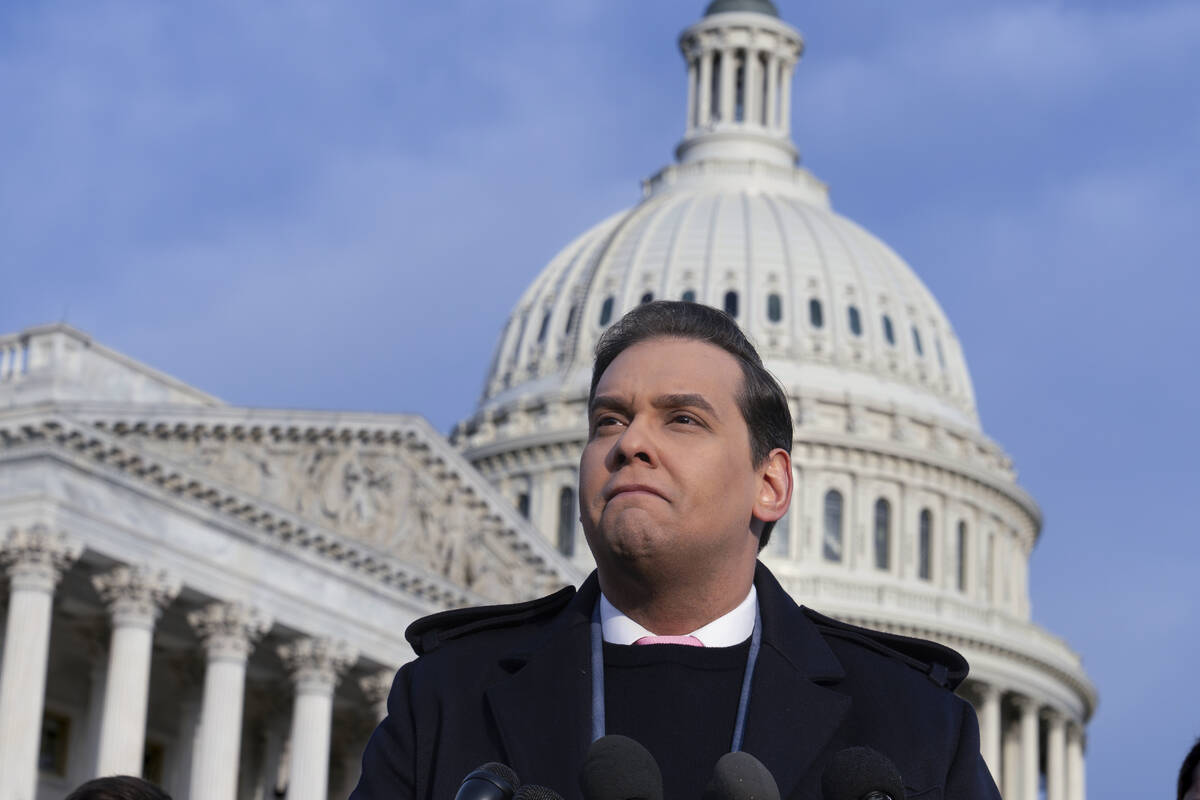 Rep. George Santos, R-N.Y., faces reporters at the Capitol in Washington, early Thursday, Nov. ...