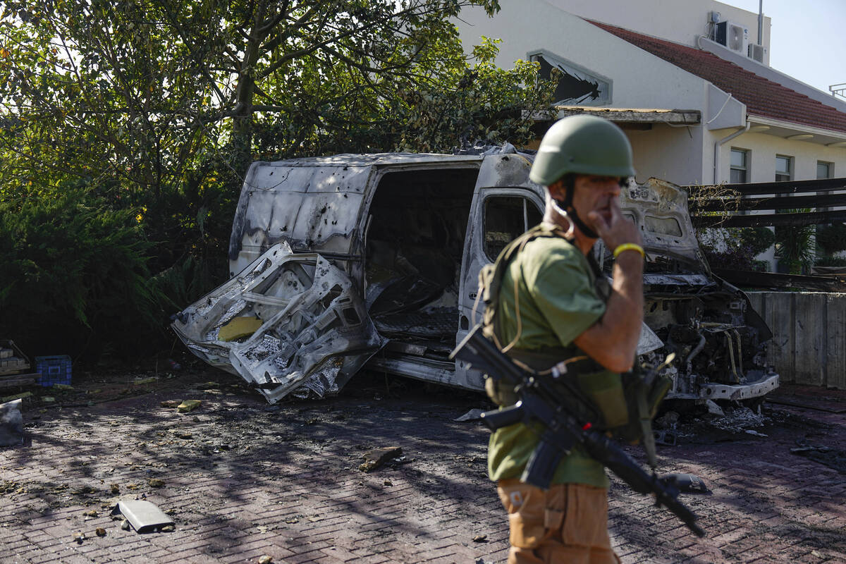 Israeli security personal inspect a site hit by a rocket fired from the Gaza Strip, In a commun ...