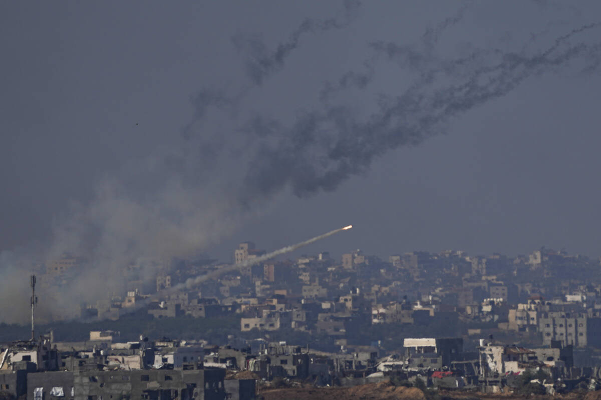 Rockets are fired toward Israel from the Gaza Strip, as seen from southern Israel, Friday, Dec. ...