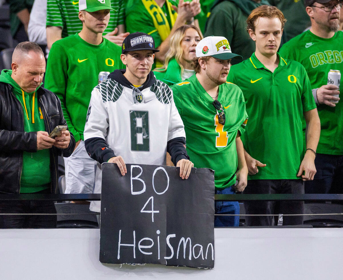 An Oregon Ducks fans is a a big Oregon Ducks quarterback Bo Nix (10) fan with others during war ...