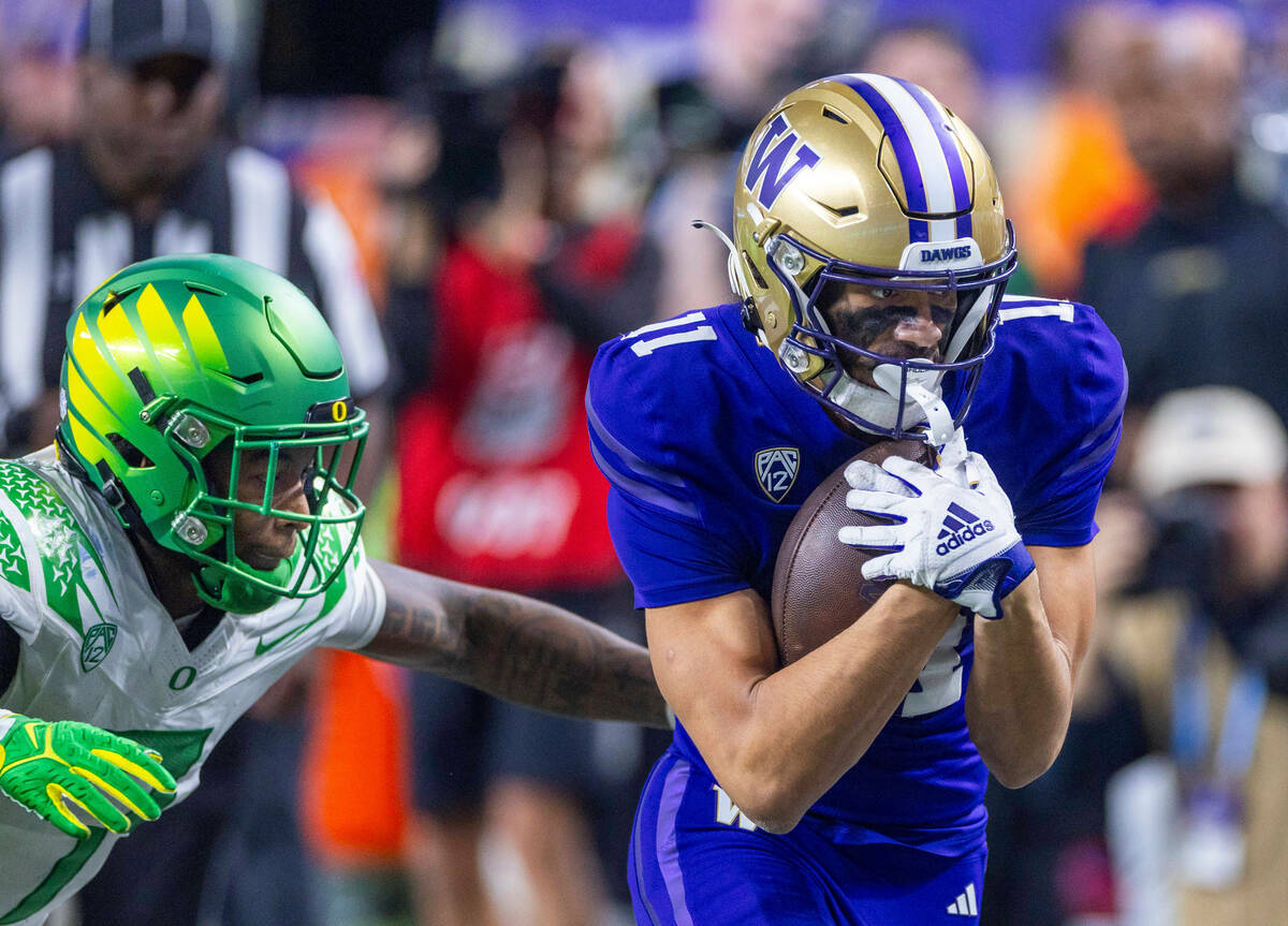 Washington Huskies wide receiver Jalen McMillan (11) catches a deep pass and nearly scores agai ...