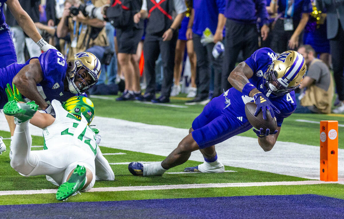 Washington Huskies wide receiver Germie Bernard (4) dives for the end zone for a touchdown past ...