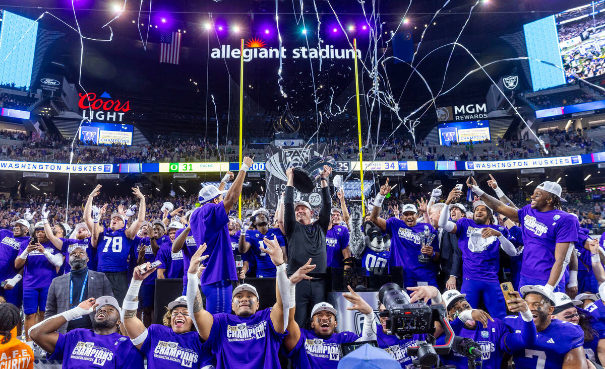 The Washington Huskies celebrate their Pac-12 Football Championship game win against the Oregon ...