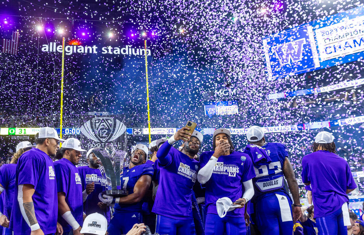 The Washington Huskies celebrate their Pac-12 Football Championship game win against the Oregon ...