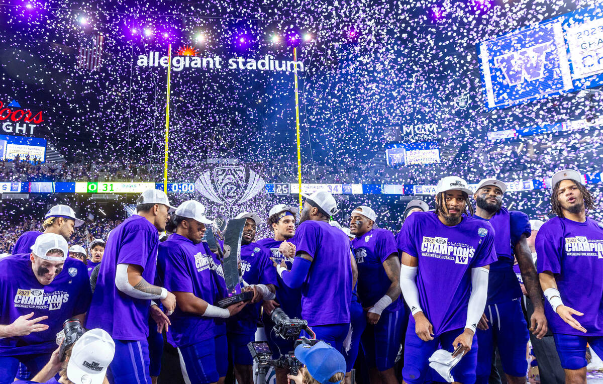 The Washington Huskies celebrate their Pac-12 Football Championship game win against the Oregon ...