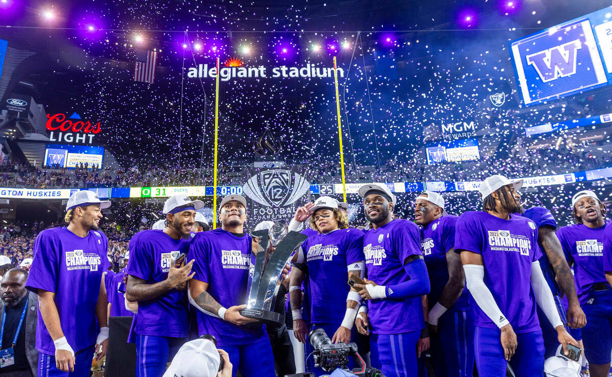 The Washington Huskies celebrate their Pac-12 Football Championship game win against the Oregon ...