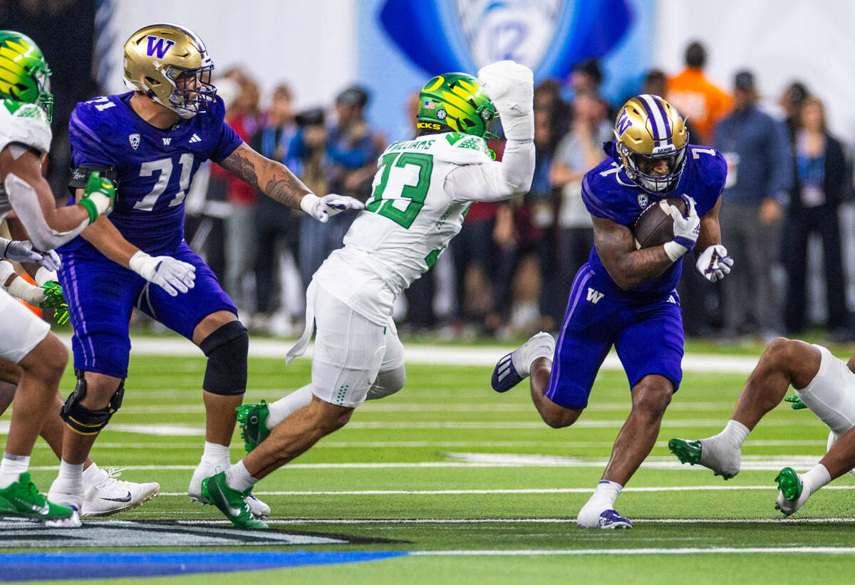 Washington Huskies running back Dillon Johnson (7) breaks free for another first down against O ...