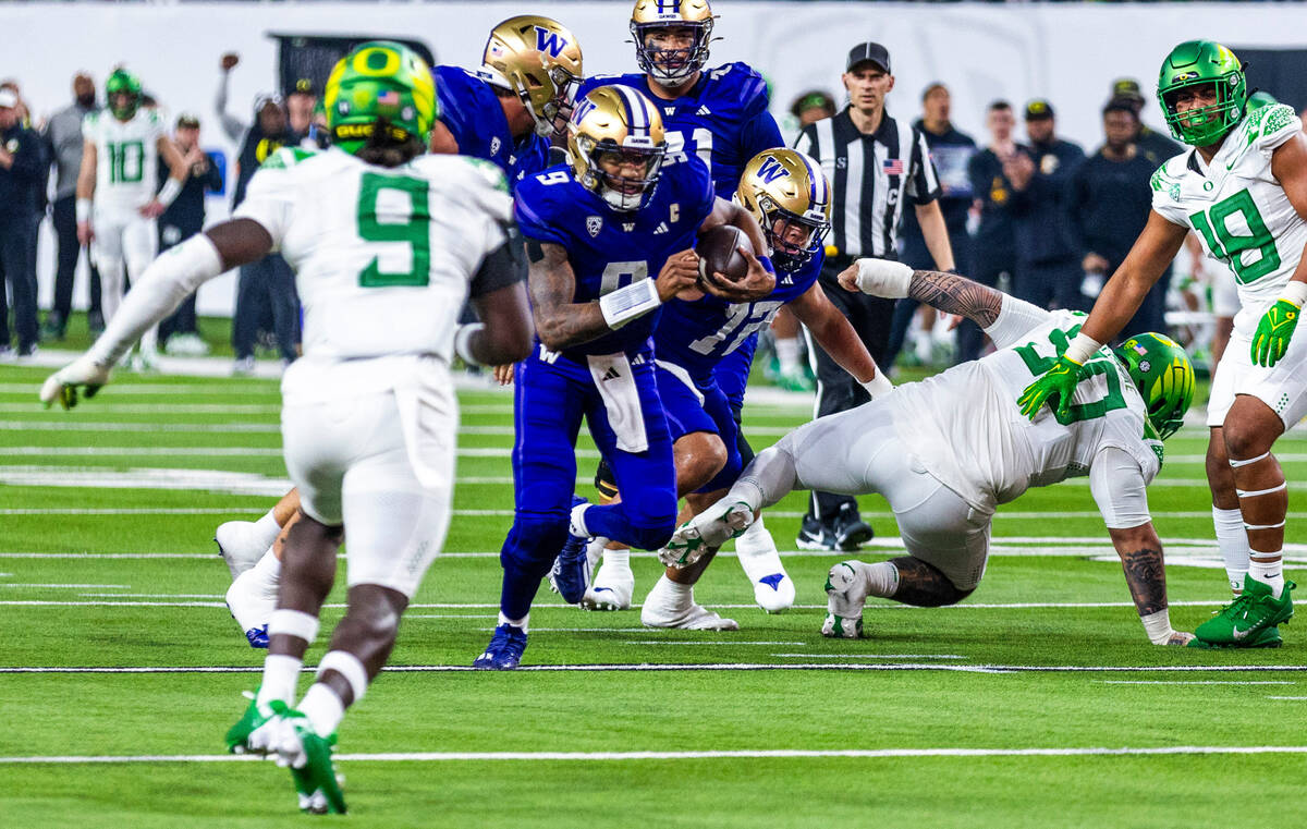 Washington Huskies quarterback Michael Penix Jr. (9) breaks through the line after a missed tac ...