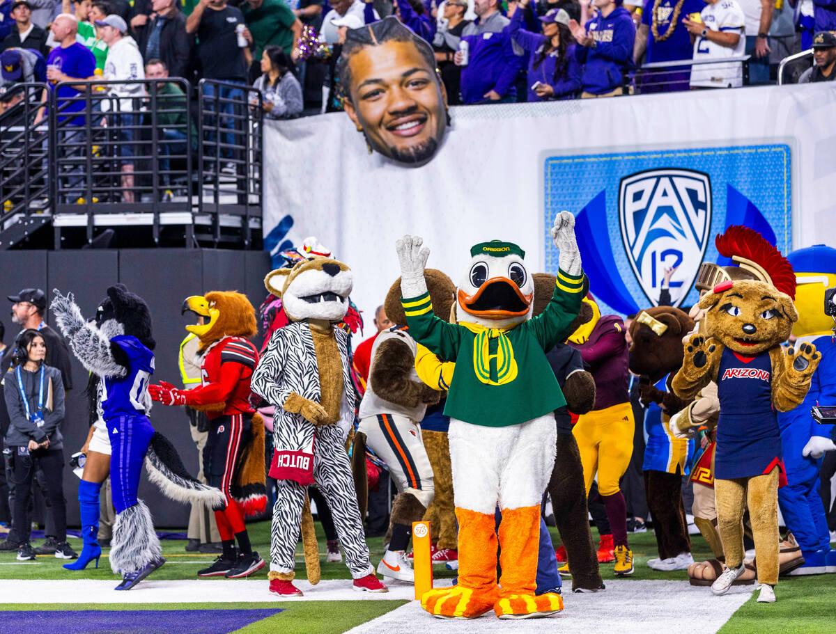 Mascots gather in the end zone for a timeout contest as the Washington Huskies battle the Orego ...