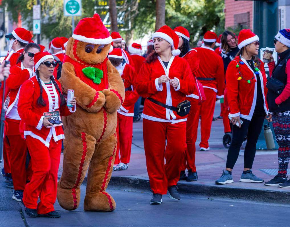 The Gingerbread Man and other participants walk to the starting line during the Las Vegas Great ...