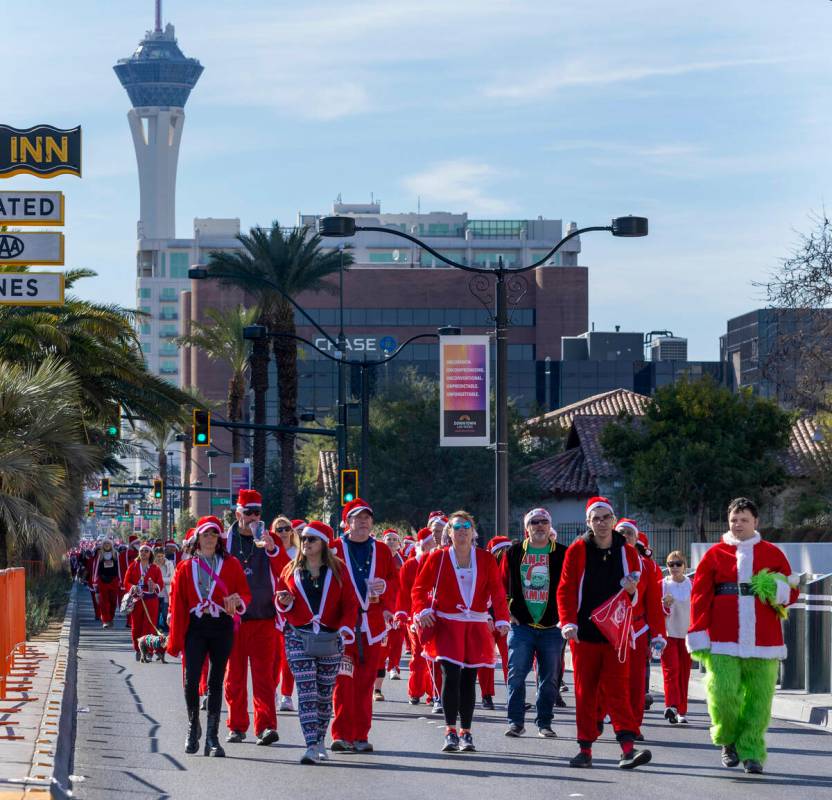 Participants in the 1-mile jaunt move up Las Vegas Boulevard heading to the finish line during ...