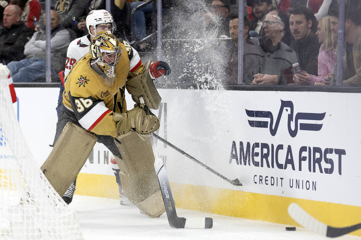 Golden Knights goaltender Logan Thompson (36) passes the puck while Capitals center Hendrix Lap ...