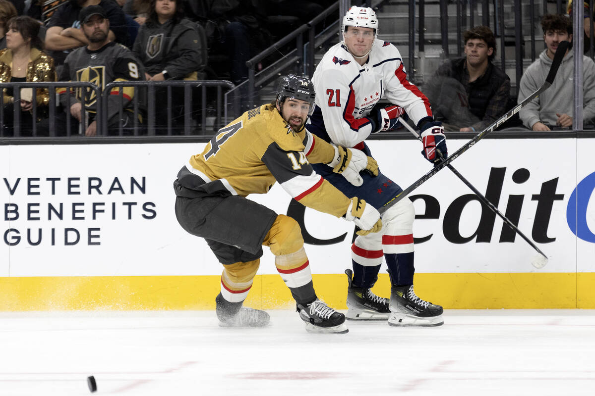 Golden Knights defenseman Nicolas Hague (14) guards Capitals center Aliaksei Protas (21) while ...