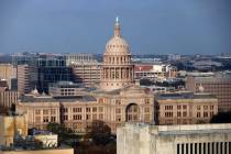 The Texas State Capitol is surrounded by buildings and the University of Texas in Austin, Texas ...