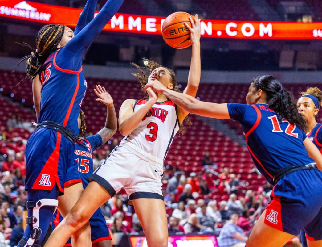 UNLV Lady Rebels guard Kiara Jackson (3) looks to shoot between Arizona Wildcats forward Breya ...