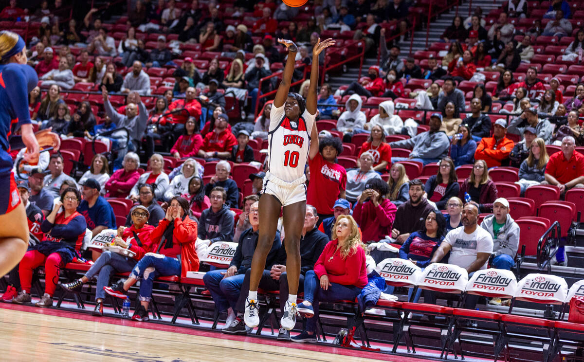 UNLV Lady Rebels guard Jasmyn Lott (10) gets off a three-point basket attempt against the Arizo ...