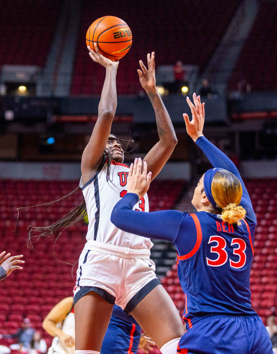 UNLV Lady Rebels center Desi-Rae Young (23) scores above Arizona Wildcats forward Isis Beh (33) ...