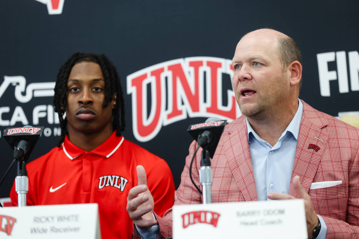 UNLV head coach Barry Odom, next to wide receiver Ricky White, addresses media at a press confe ...